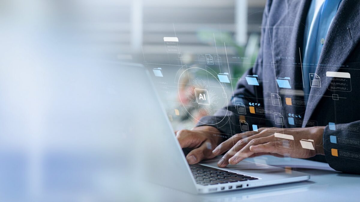 Zomed in picture of someone on a laptop and showing technology