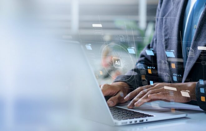 Zomed in picture of someone on a laptop and showing technology