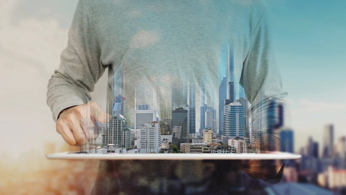 A man holding digital concept of commercial real estate