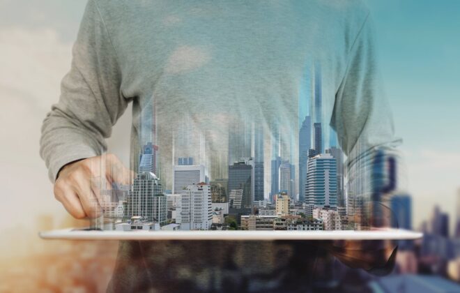 A man holding digital concept of commercial real estate